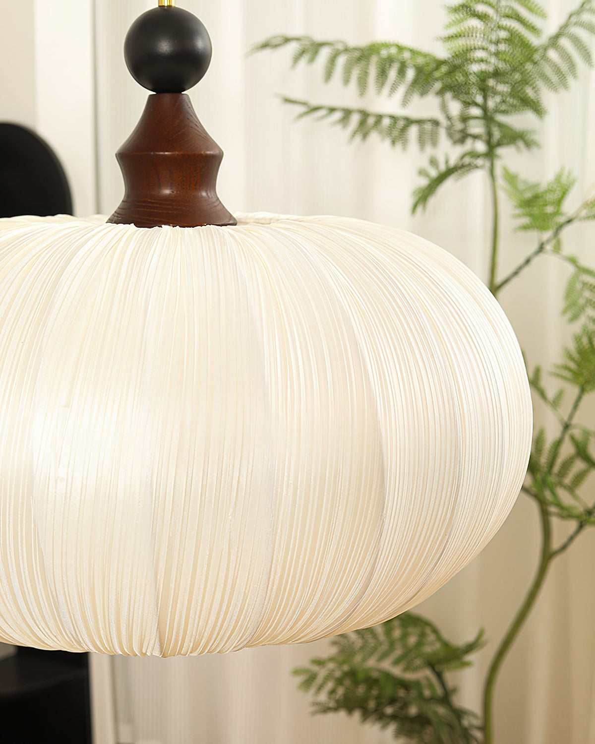 Lifestyle image of the Bowie Pendant Light in a cozy bedroom setting.