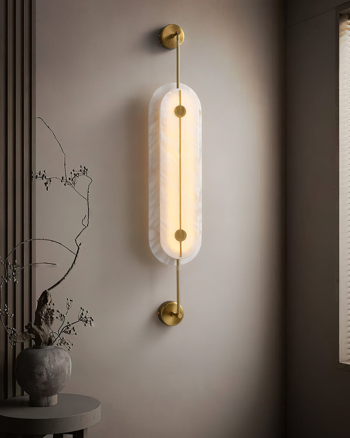 The medium size variant of the Brace Alabaster Wall Lamp.