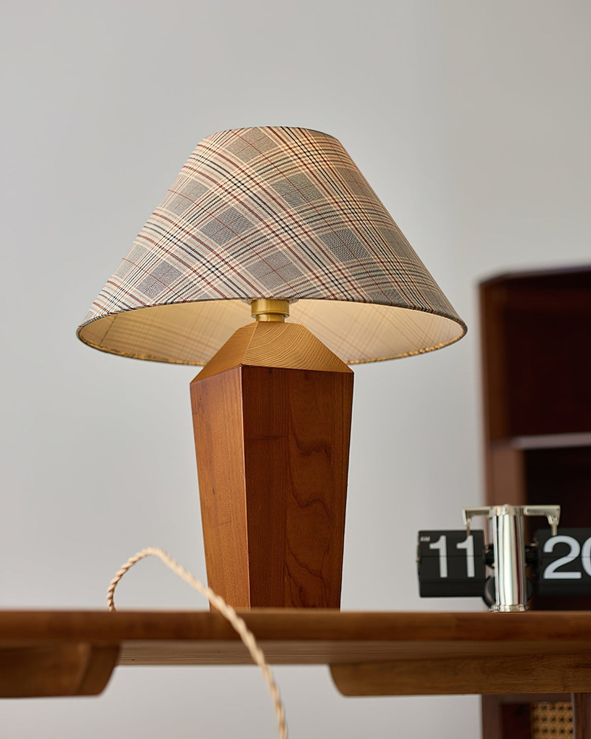 Close-up of the classic plaid pattern on the lamp's fabric shade.