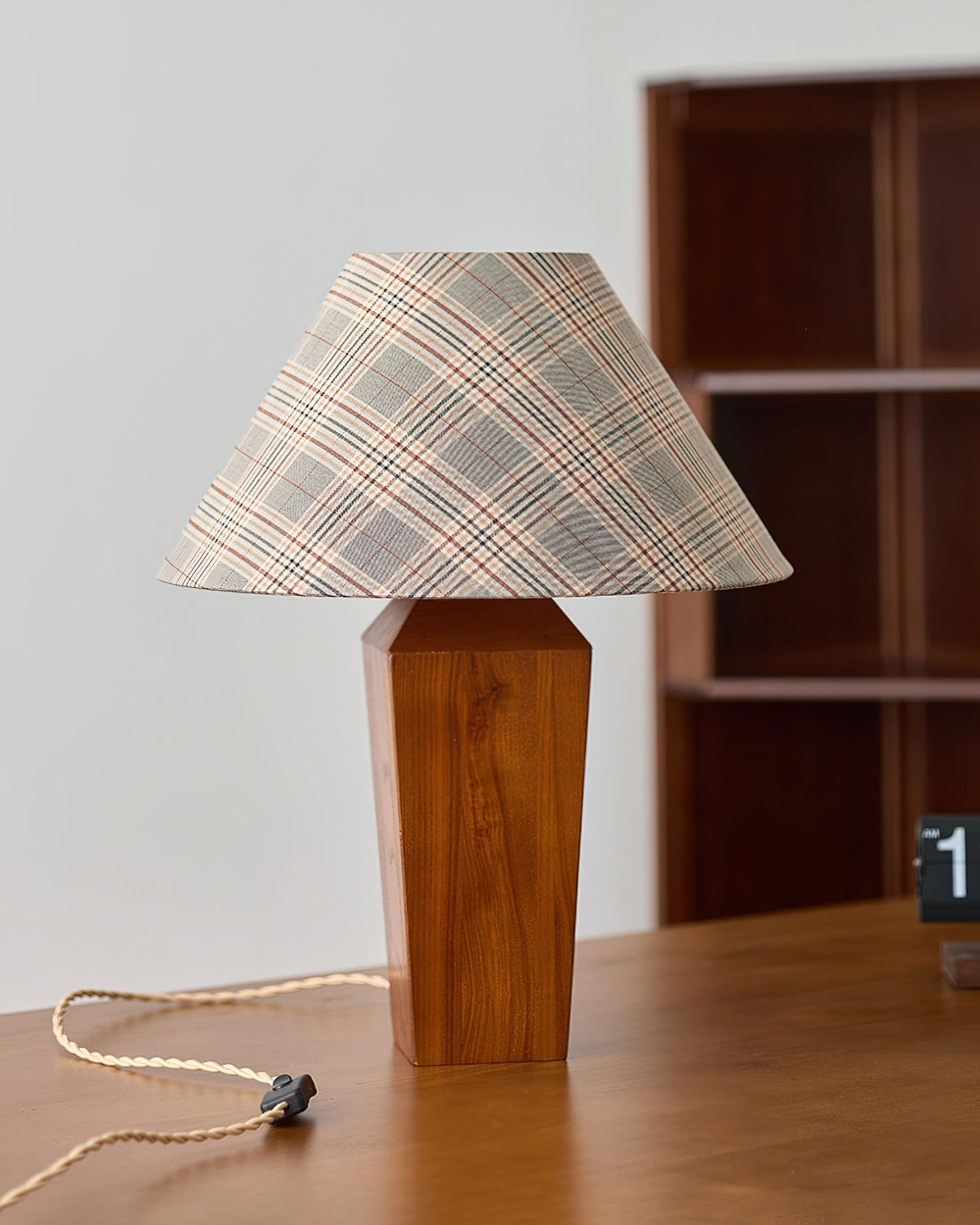 The Cabin Table Lamp illuminated, casting a warm and inviting glow.