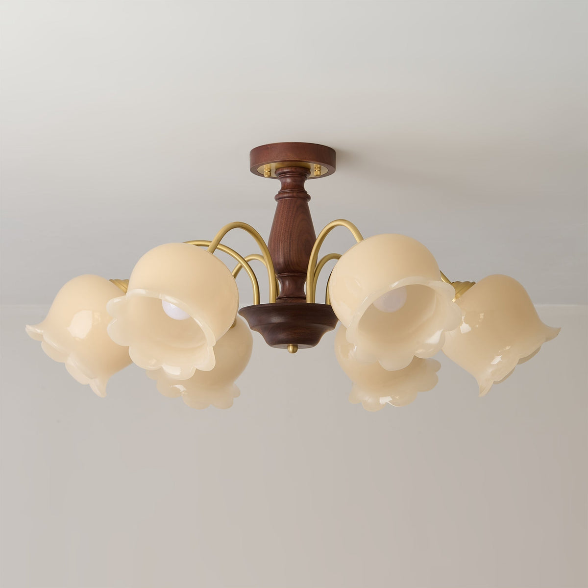 A single cream-colored glass flower shade, showing its delicate texture.