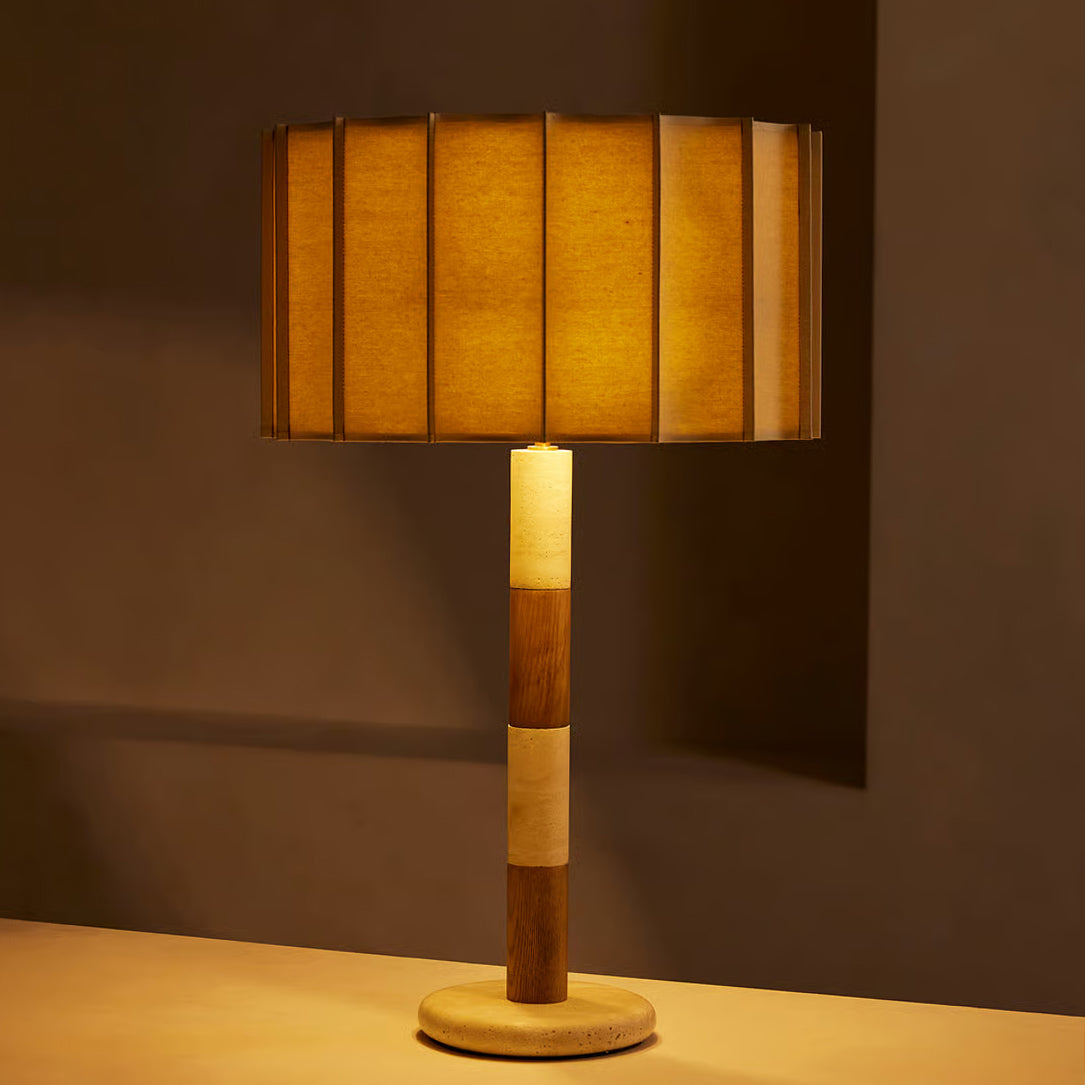 Close-up of the Calypso Table Lamp's stacked travertine and wood base.