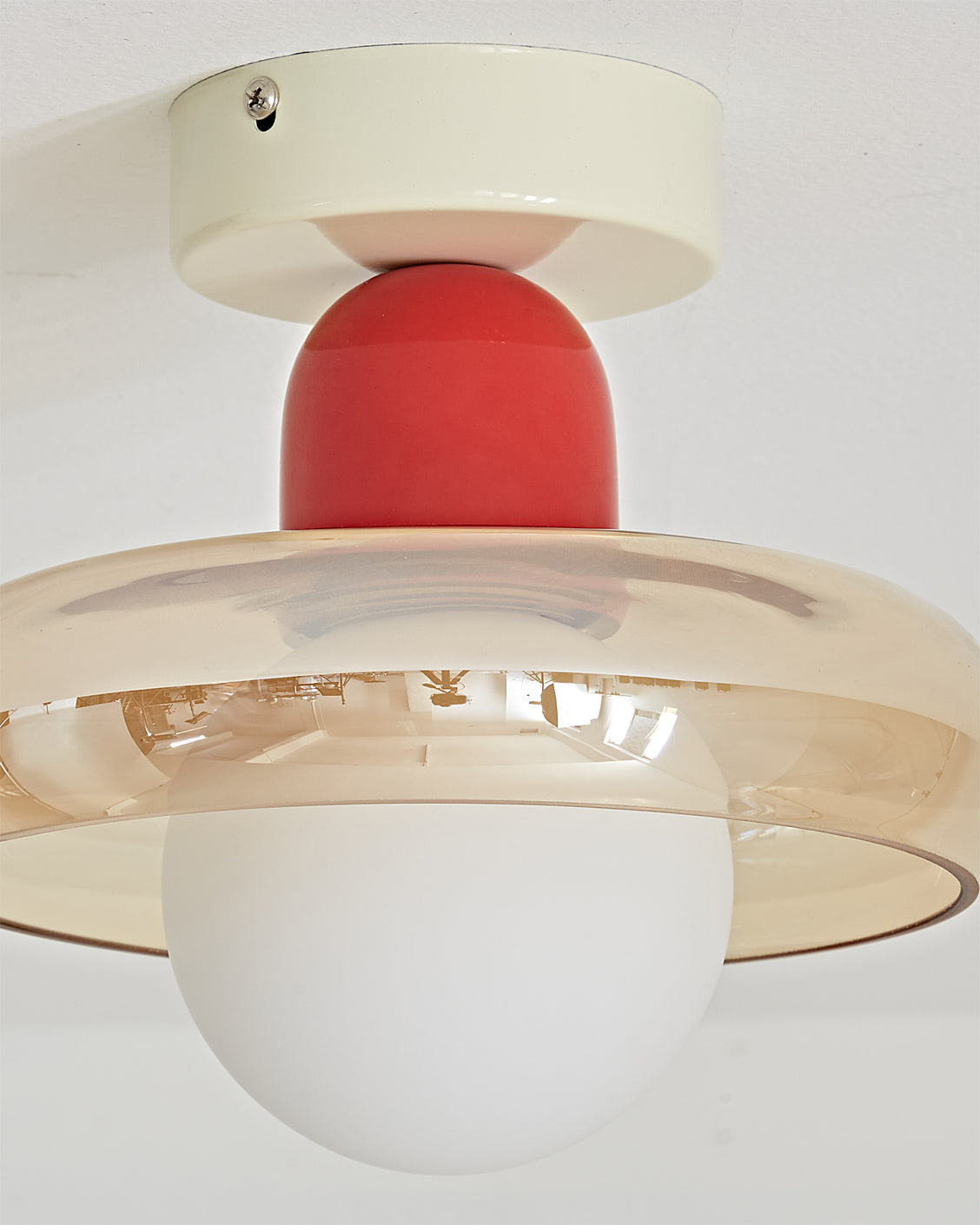 The Alabax Ceiling Light lit, showing how the light diffuses through the colored glass.