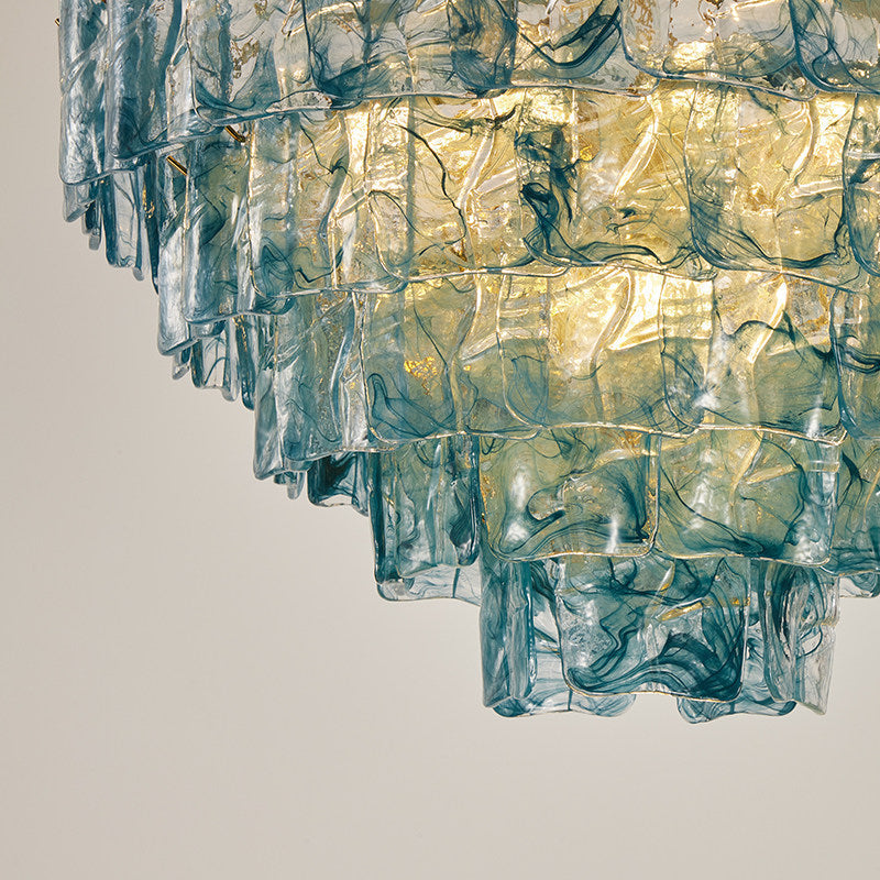 Clementine chandelier with gold-tinted glass panels in a luxurious living room setting.