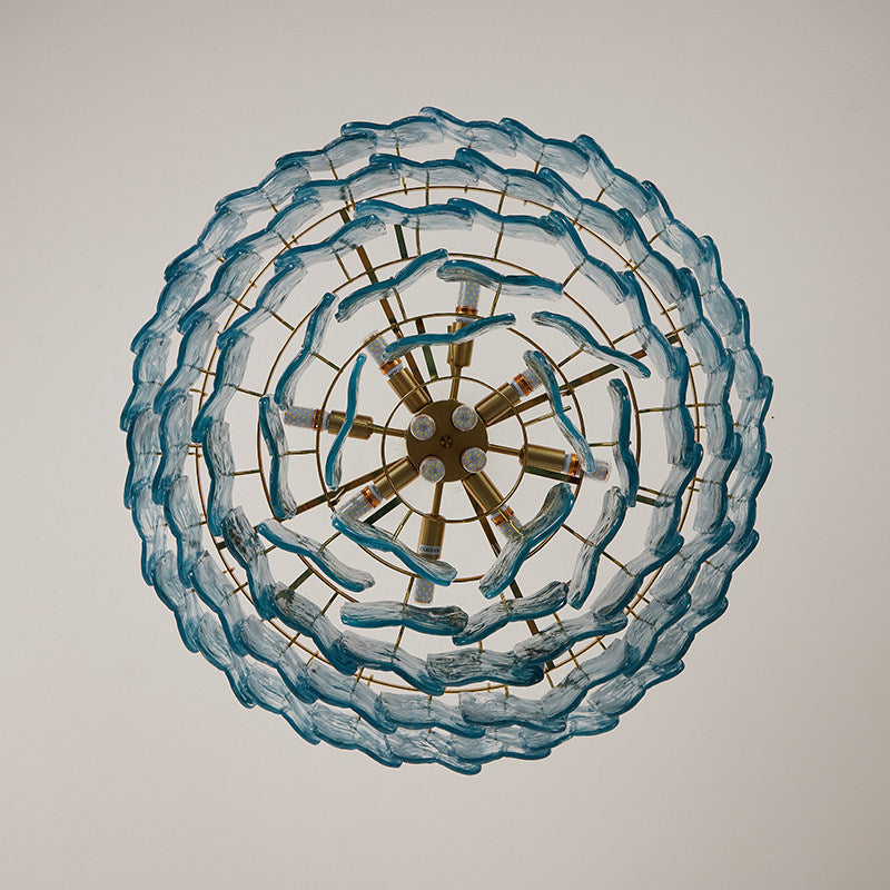 Angled view of the gold Clementine chandelier, showcasing its multi-tiered design.