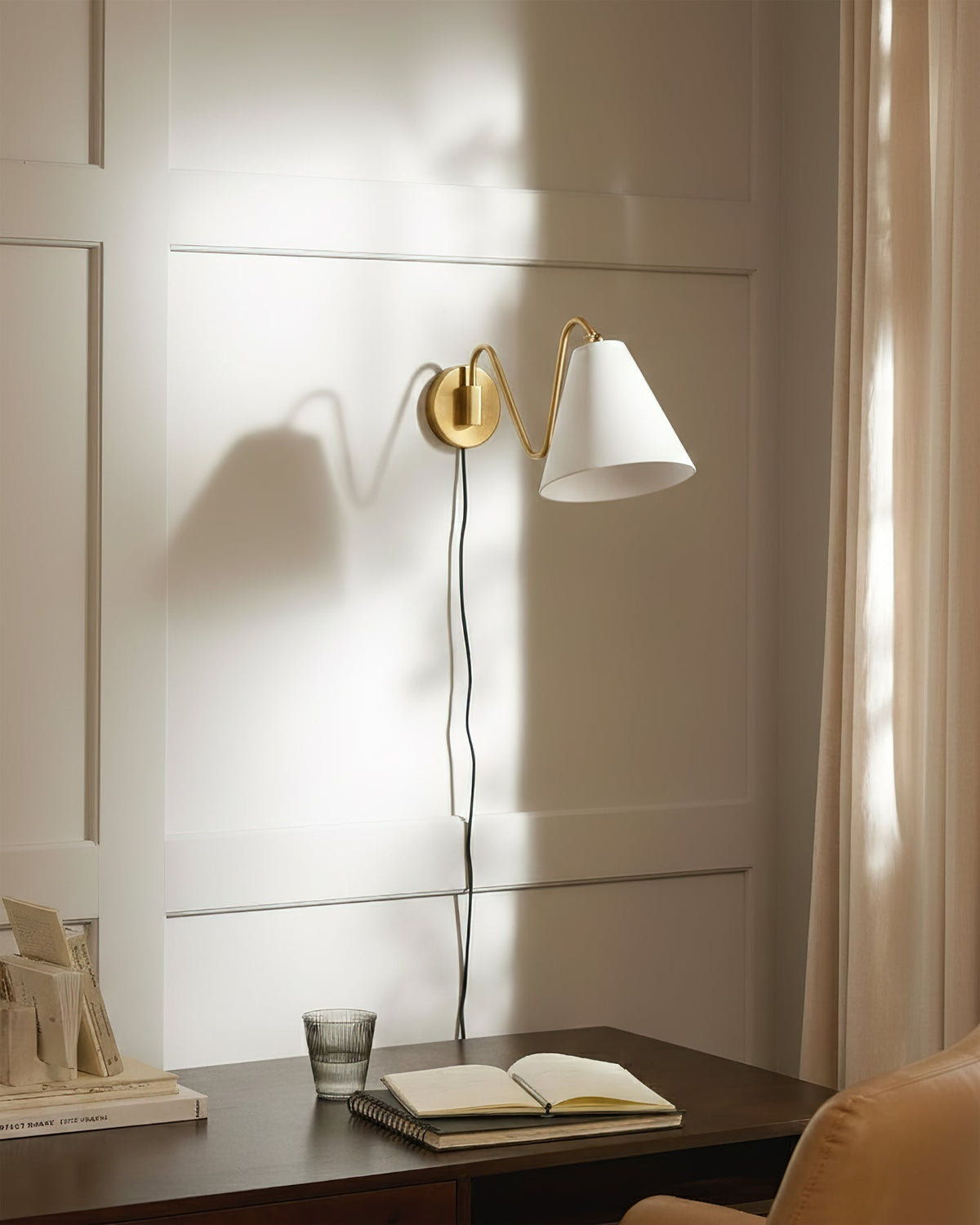 The one-head Cleome wall lamp shown in a bedroom setting above a nightstand.