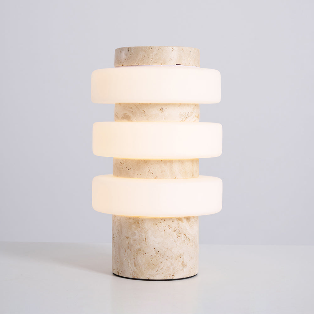 The Corba Table Lamp turned on, casting a warm glow.