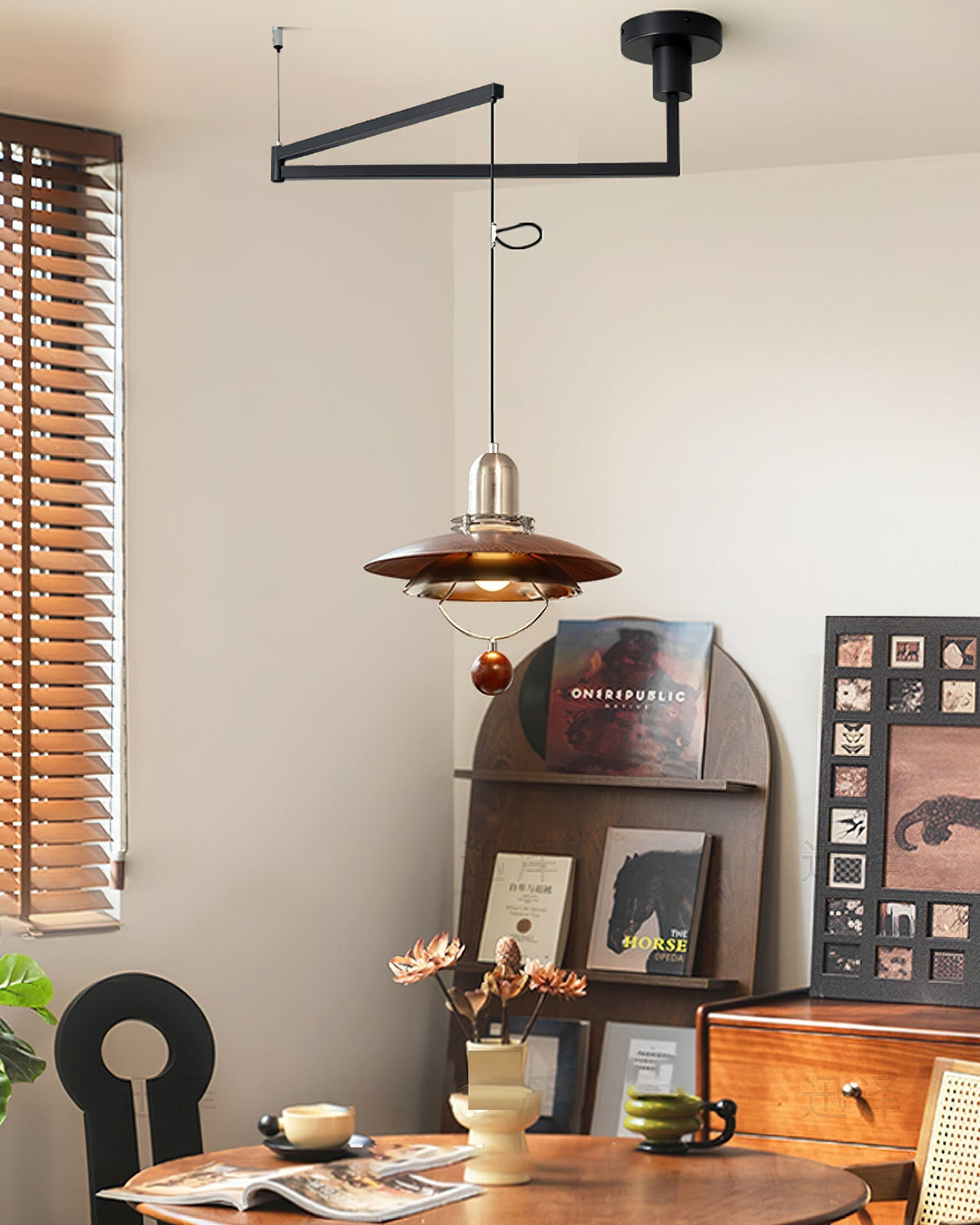 Cullen Swing Arm Pendant Light installed over a modern dining area.