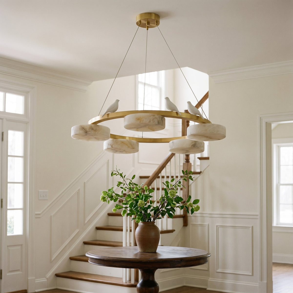 Detail shot of a white sculptural bird perched on the chandelier.