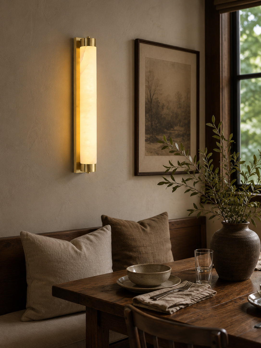 Langham Alabaster Wall Sconce shown in a bathroom setting next to a mirror.