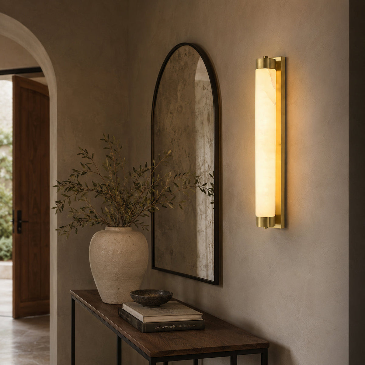 Lifestyle image of the sconce in a sophisticated powder room.