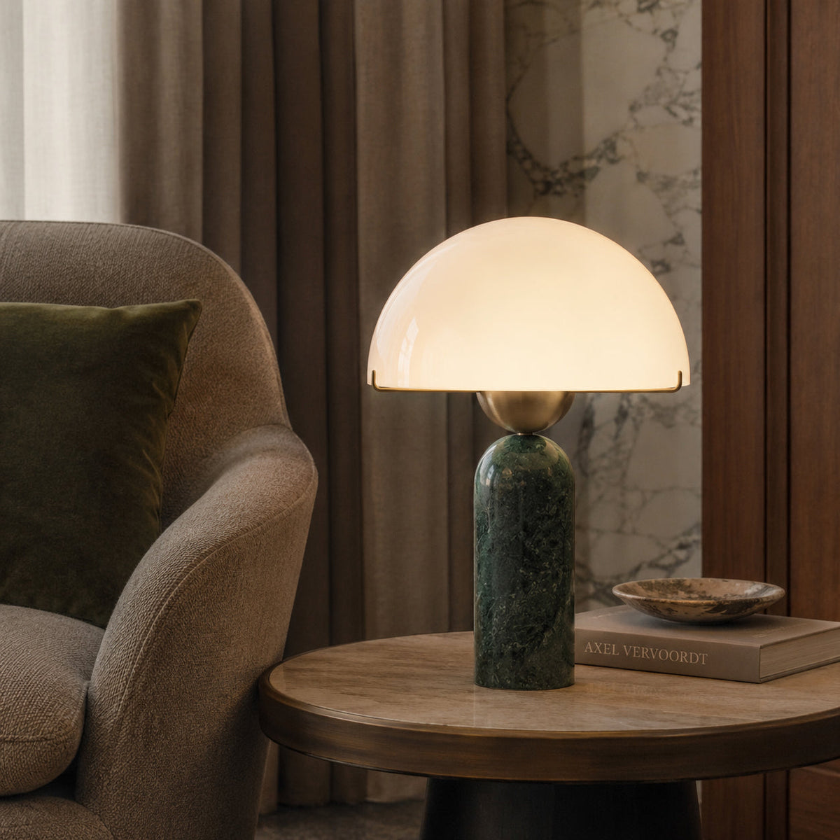 The glass shade of the Milano Table Lamp glowing with warm, ambient light.