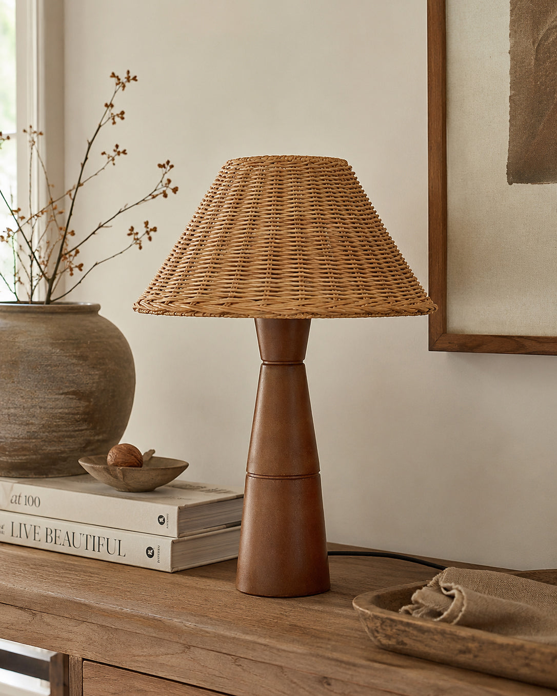 The Zaya Table Lamp illuminating a living room side table.