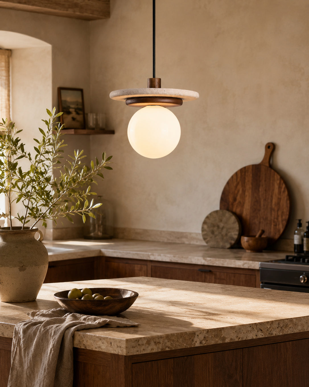 The frosted glass globe diffuser of the Farren pendant emitting a soft, warm glow.