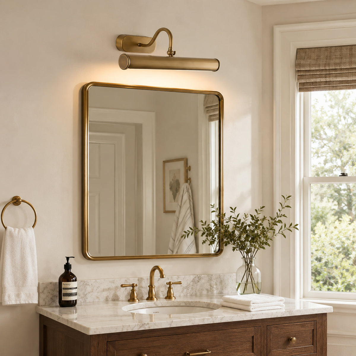 Ainsworth Wall Sconce used as a vanity light over a bathroom mirror.