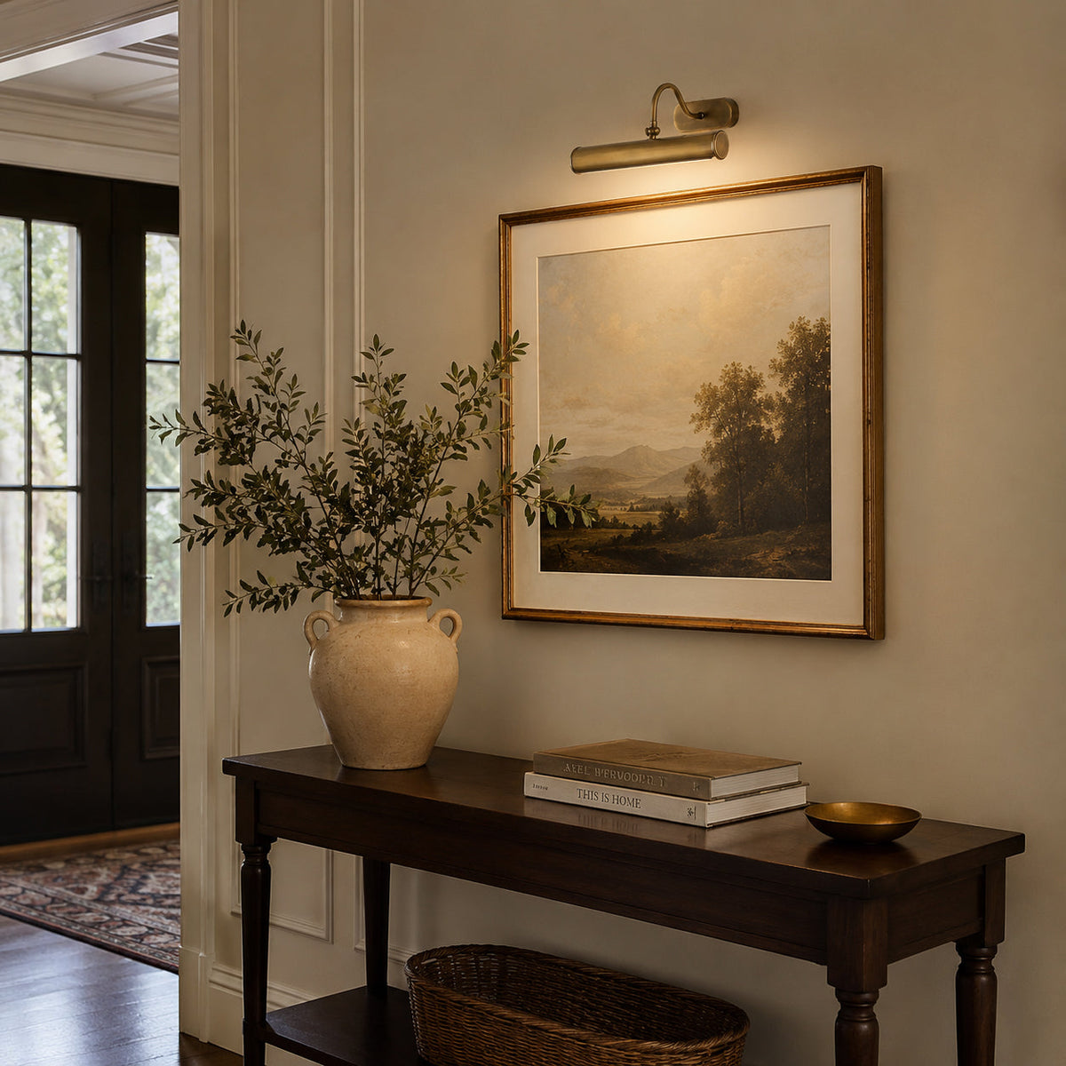 The Ainsworth Wall Sconce illuminating a fireplace mantel.