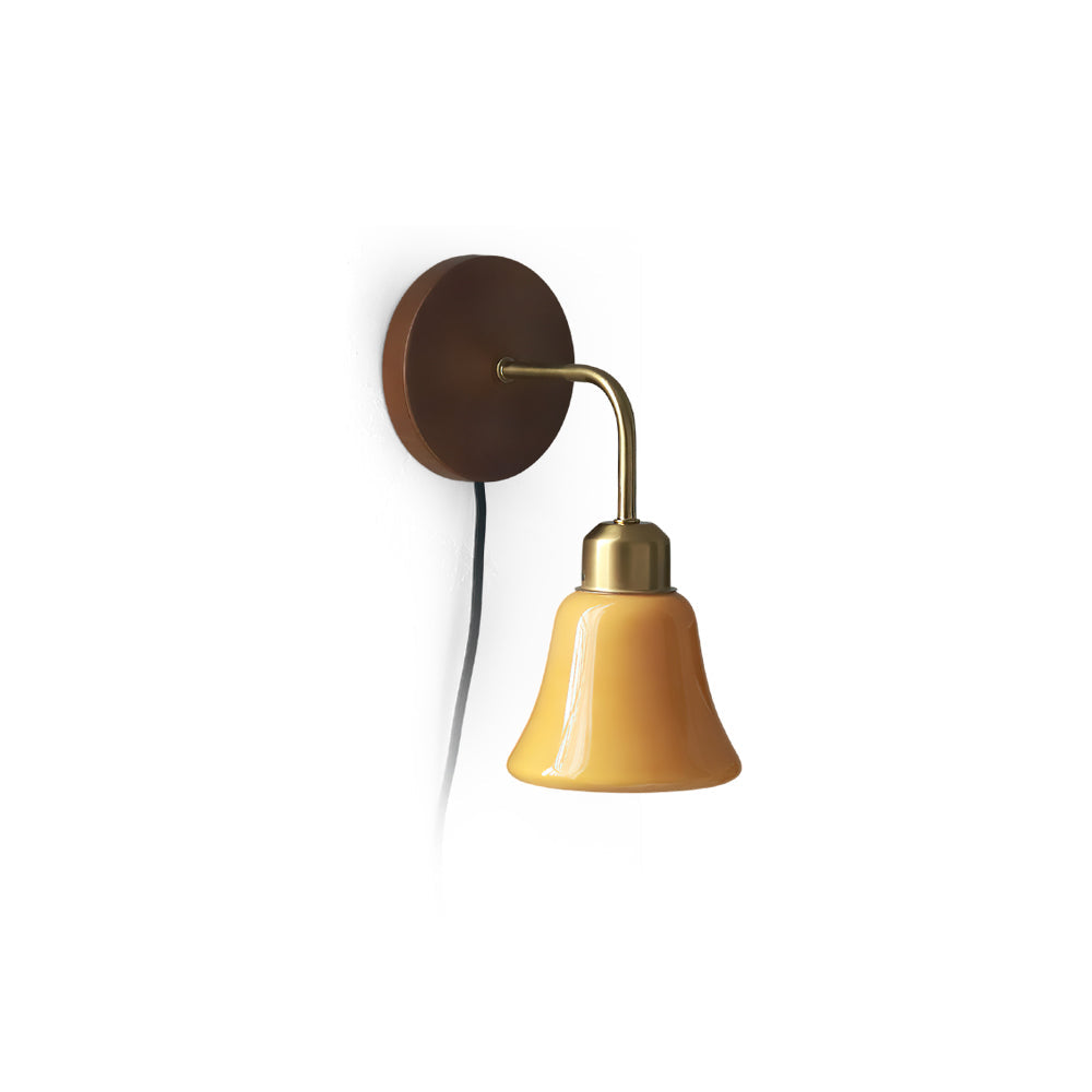 Daphne Pastel Plug-In Wall Sconce with orange glass shade and walnut backplate.