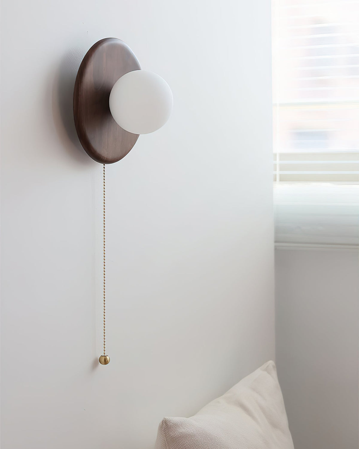 Abel wall light shown in a modern living room setting.