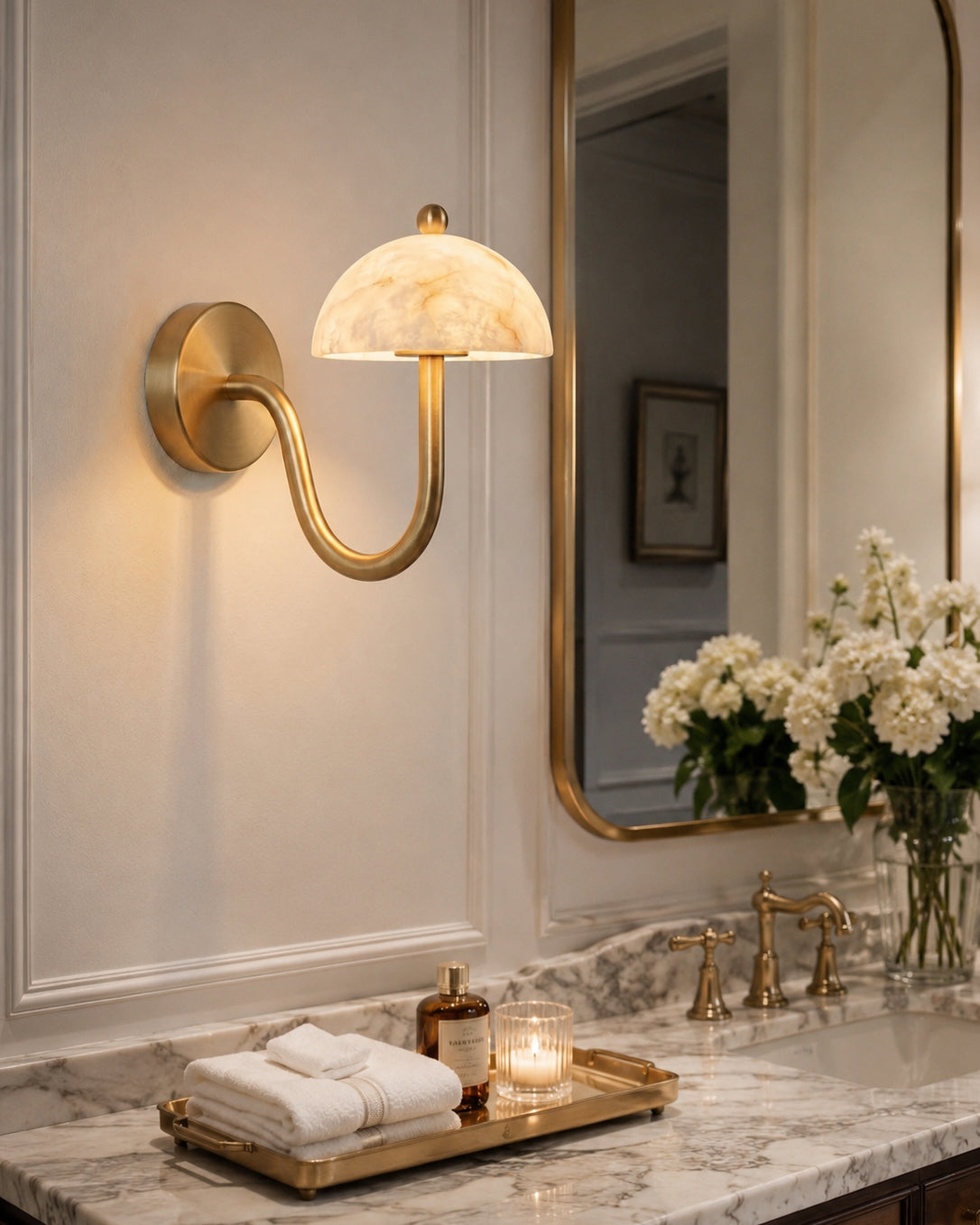 The wall sconce installed in a modern bathroom next to a vanity mirror.