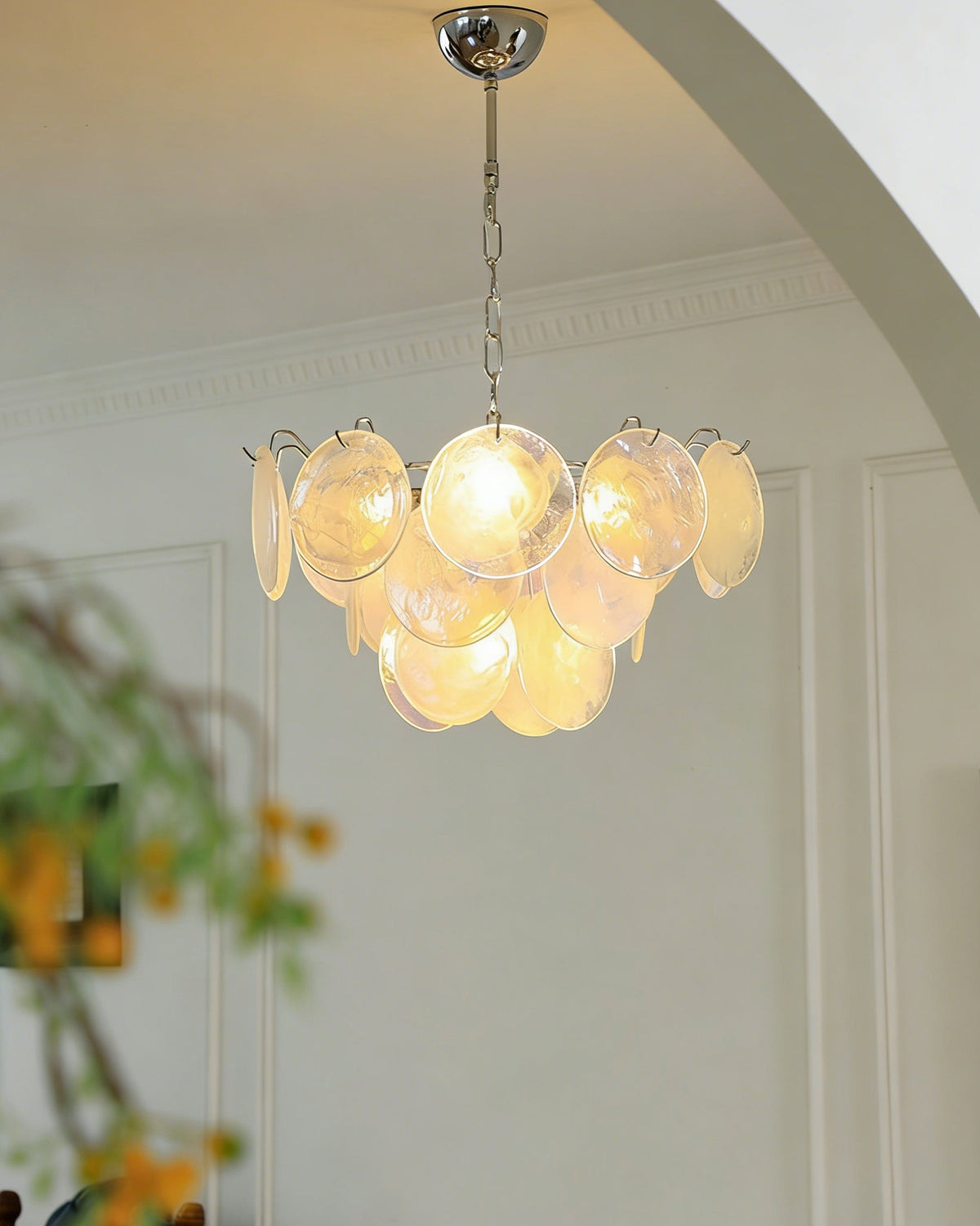 The Brette chandelier shown with white iridescent glass disks.