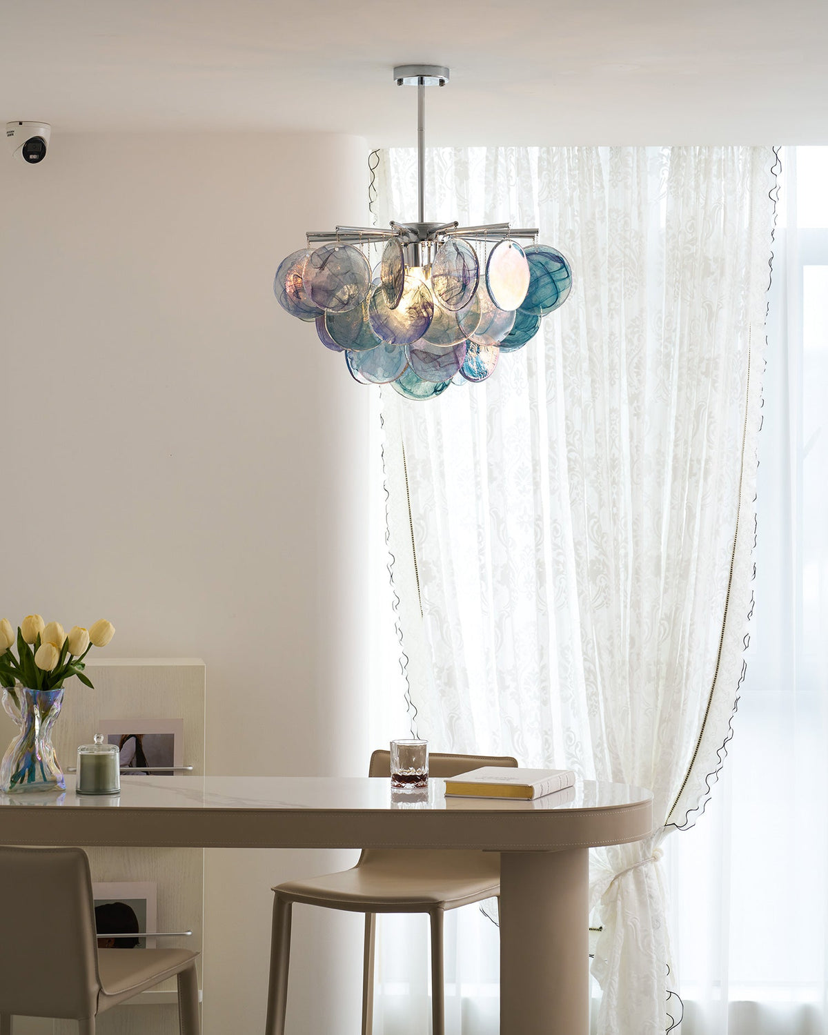 The Camisa Glass Chandelier in a minimalist interior.