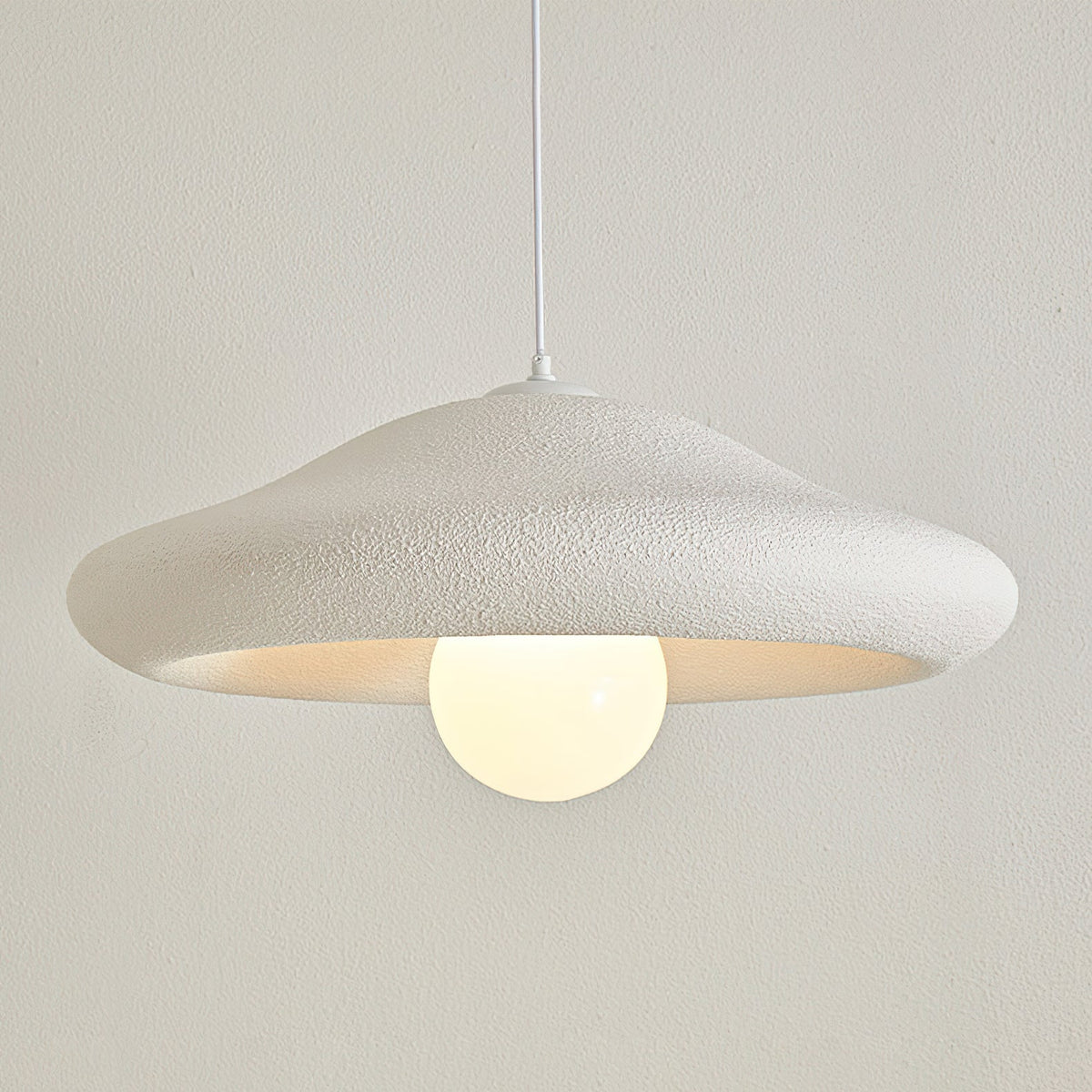 A lifestyle shot showing the scale of the Chalk Pendant Light in a room.