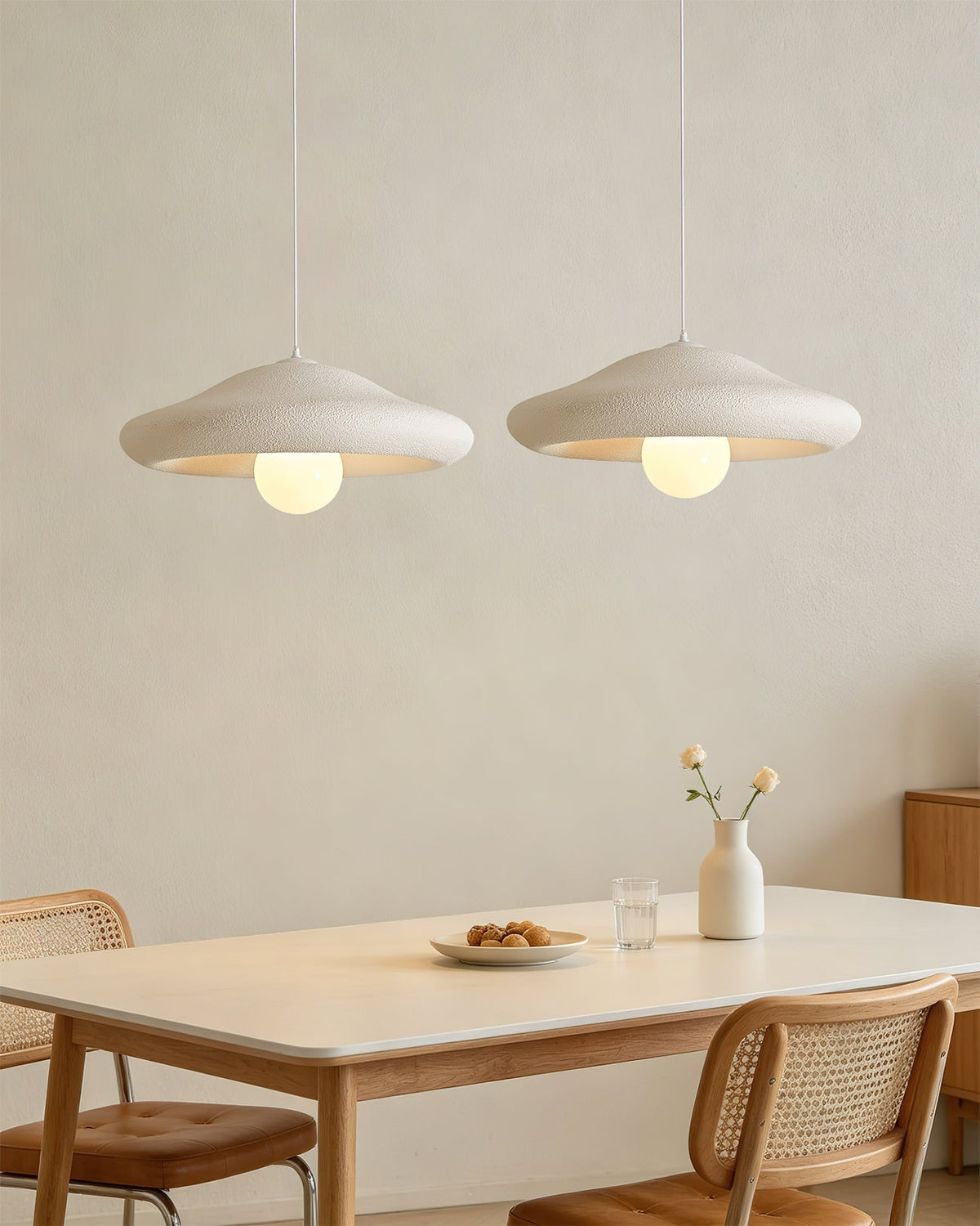 The Chalk Pendant Light hanging over a minimalist wooden dining table.