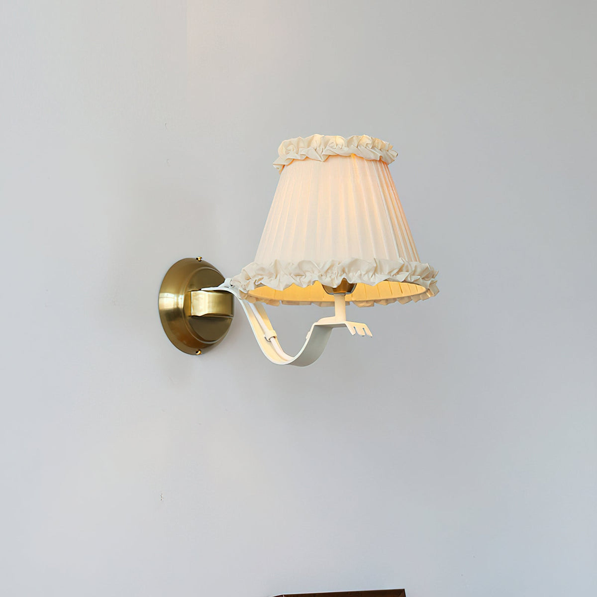 Lifestyle image of the sconce in a cozy reading nook.