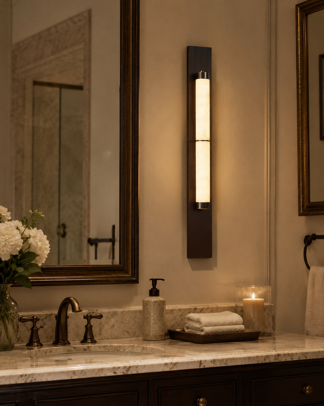 A pair of Columnar Alabaster Wall Lamps flanking a bathroom mirror.