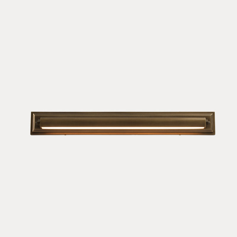 The Davenport Wall Sconce against a dark wall, emphasizing its antique brass color.
