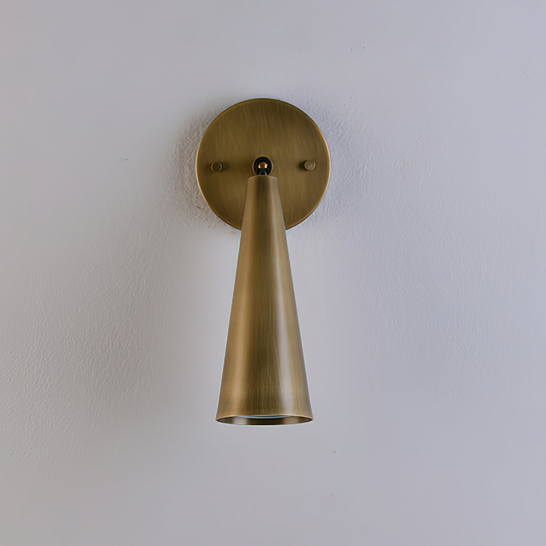 Donna Swivel Sconce in brass finish, angled for reading.