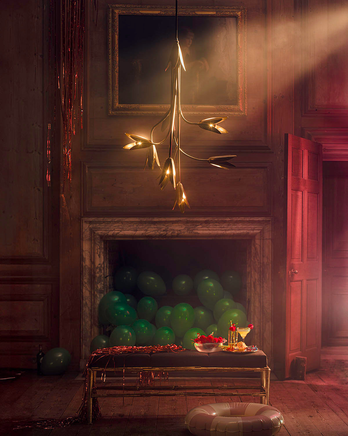 The Evadne Chandelier illuminated, casting a warm glow.