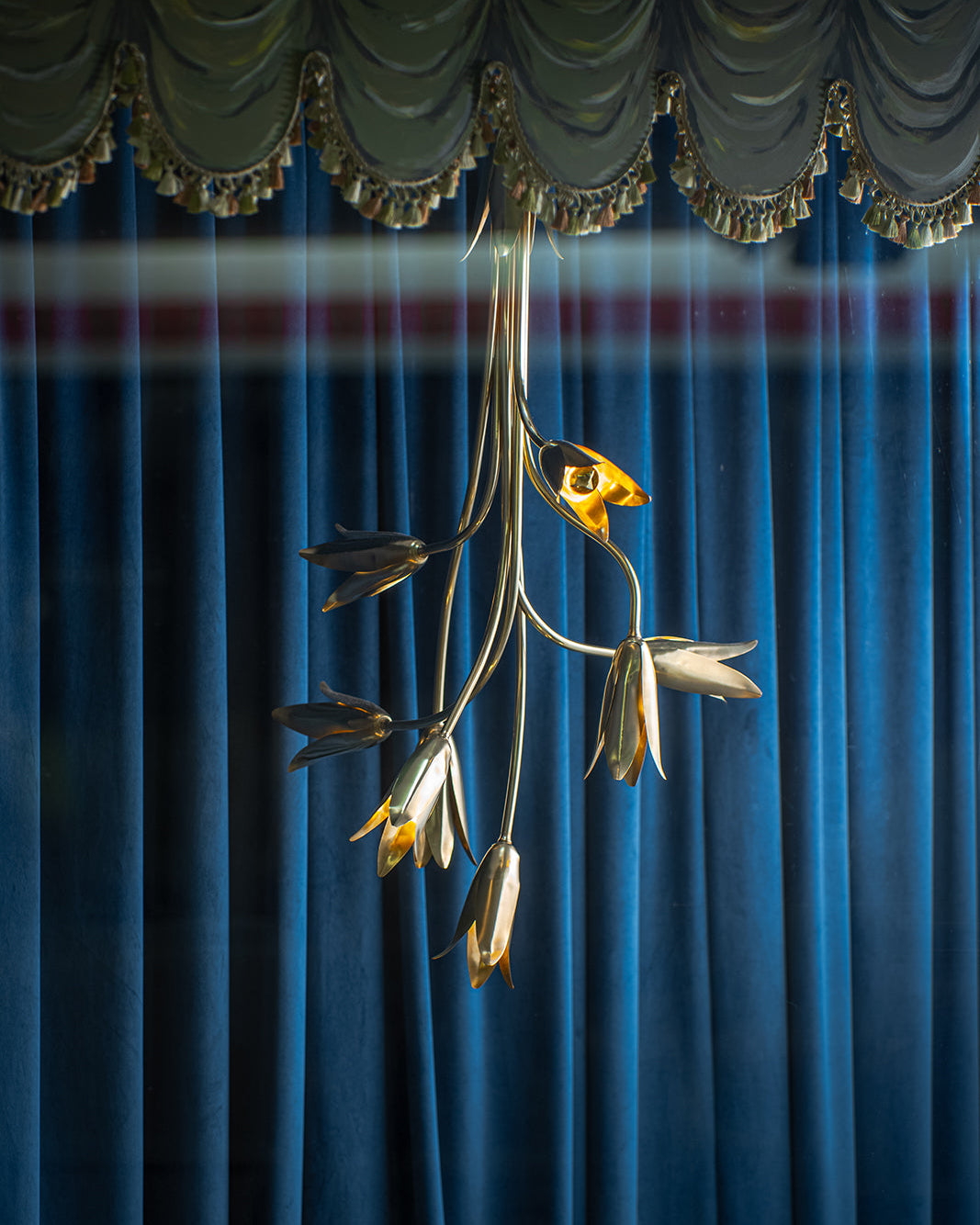 Evadne Brass Tulip Chandelier styled in a grand entryway with high ceilings.
