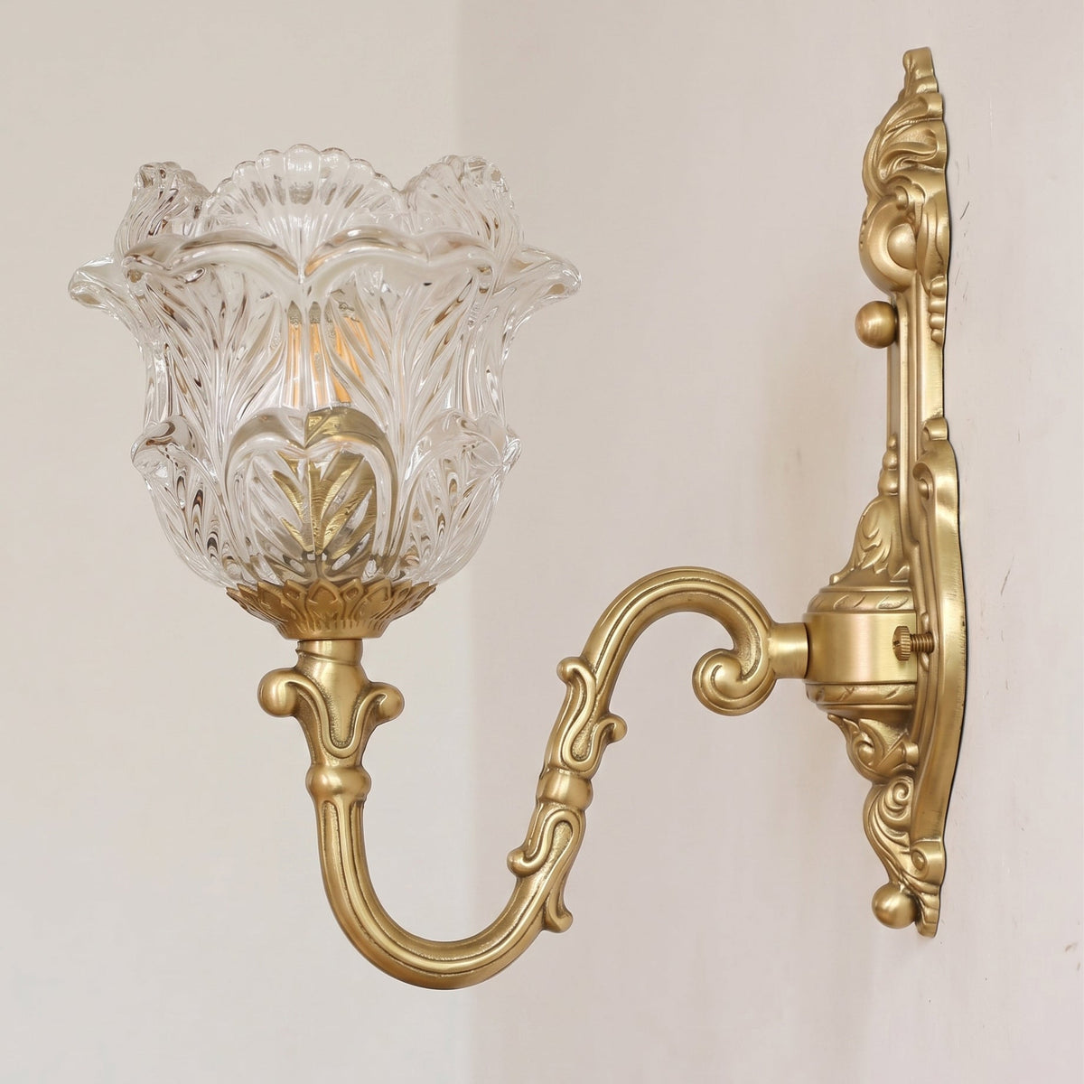 Front view of the Gideon Baroque Brass Sconce highlighting its S-shaped scroll arm.