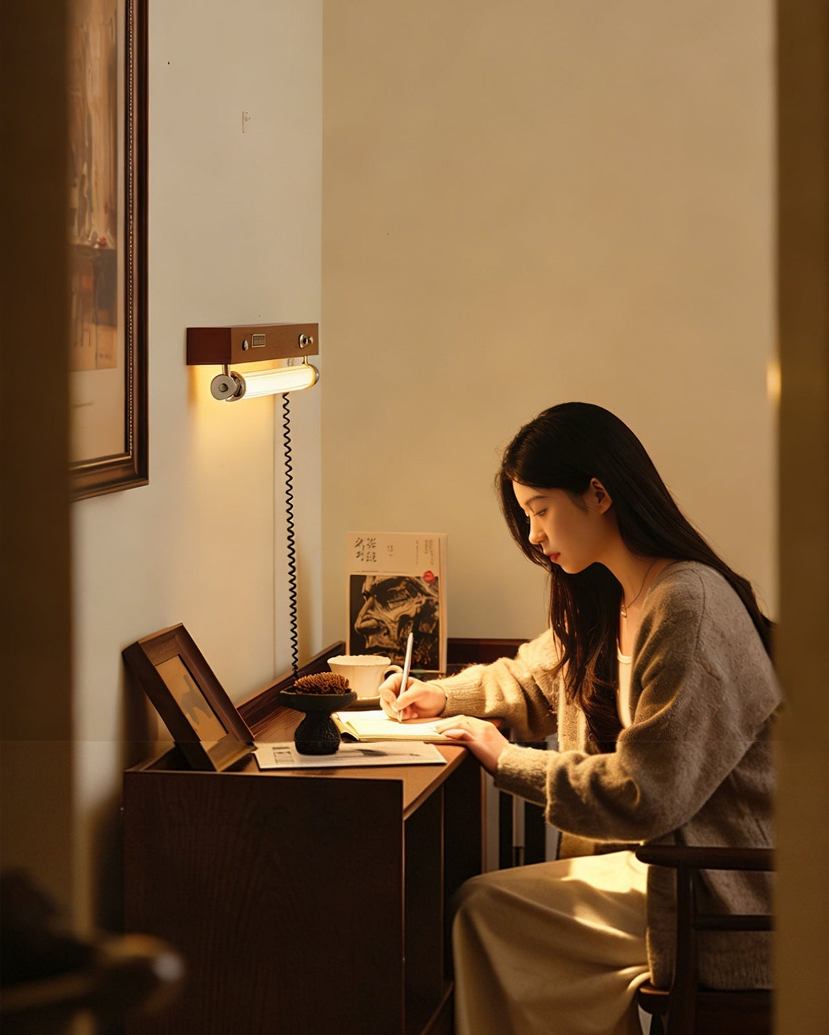 The Hopper Wall Sconce used as a bedside reading light above a nightstand.