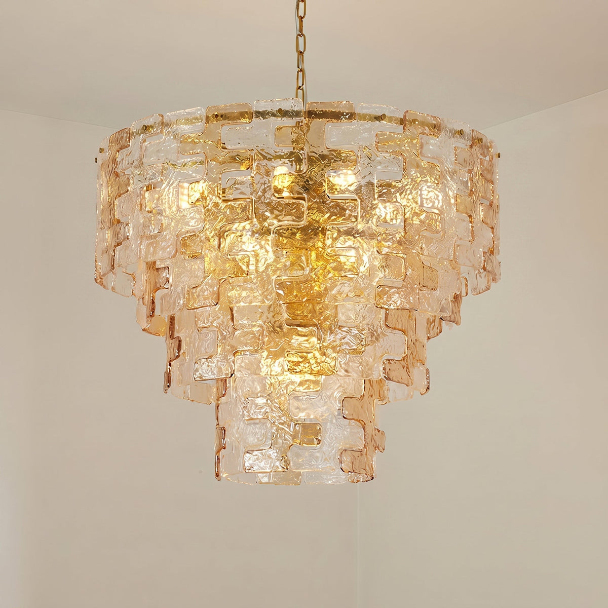 The warm glow of the Jigsaw Chandelier when illuminated.