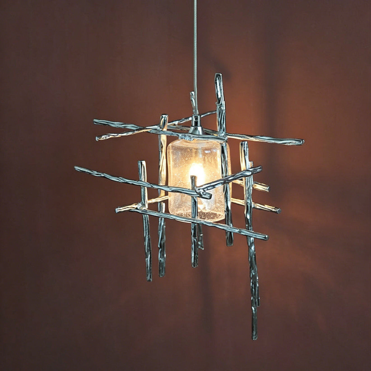 A Kova Glass Pendant Light hanging over a contemporary kitchen island.