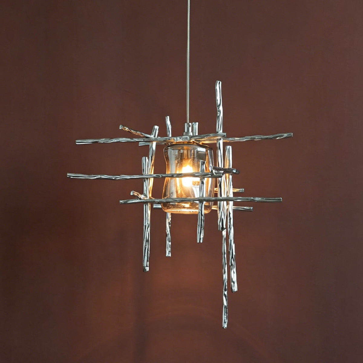 The Kova Pendant Light illuminated, casting a warm glow.