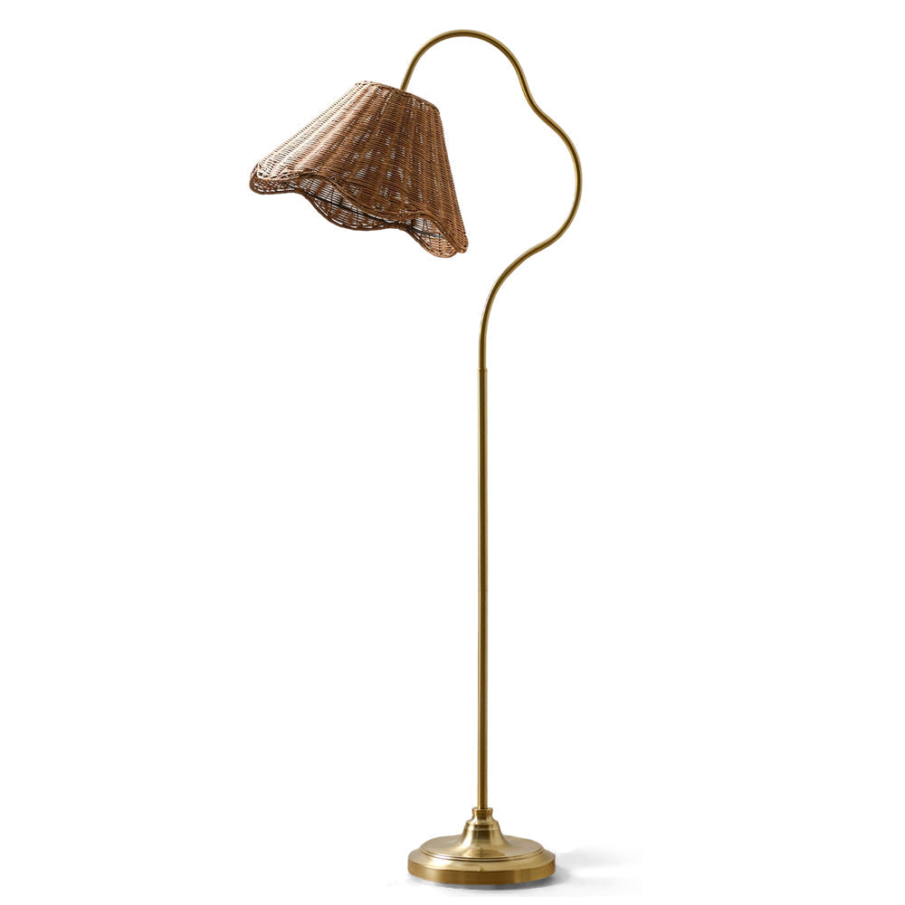 Lucinda Rattan Floor Lamp with a hand-woven scalloped shade in a cozy living room.