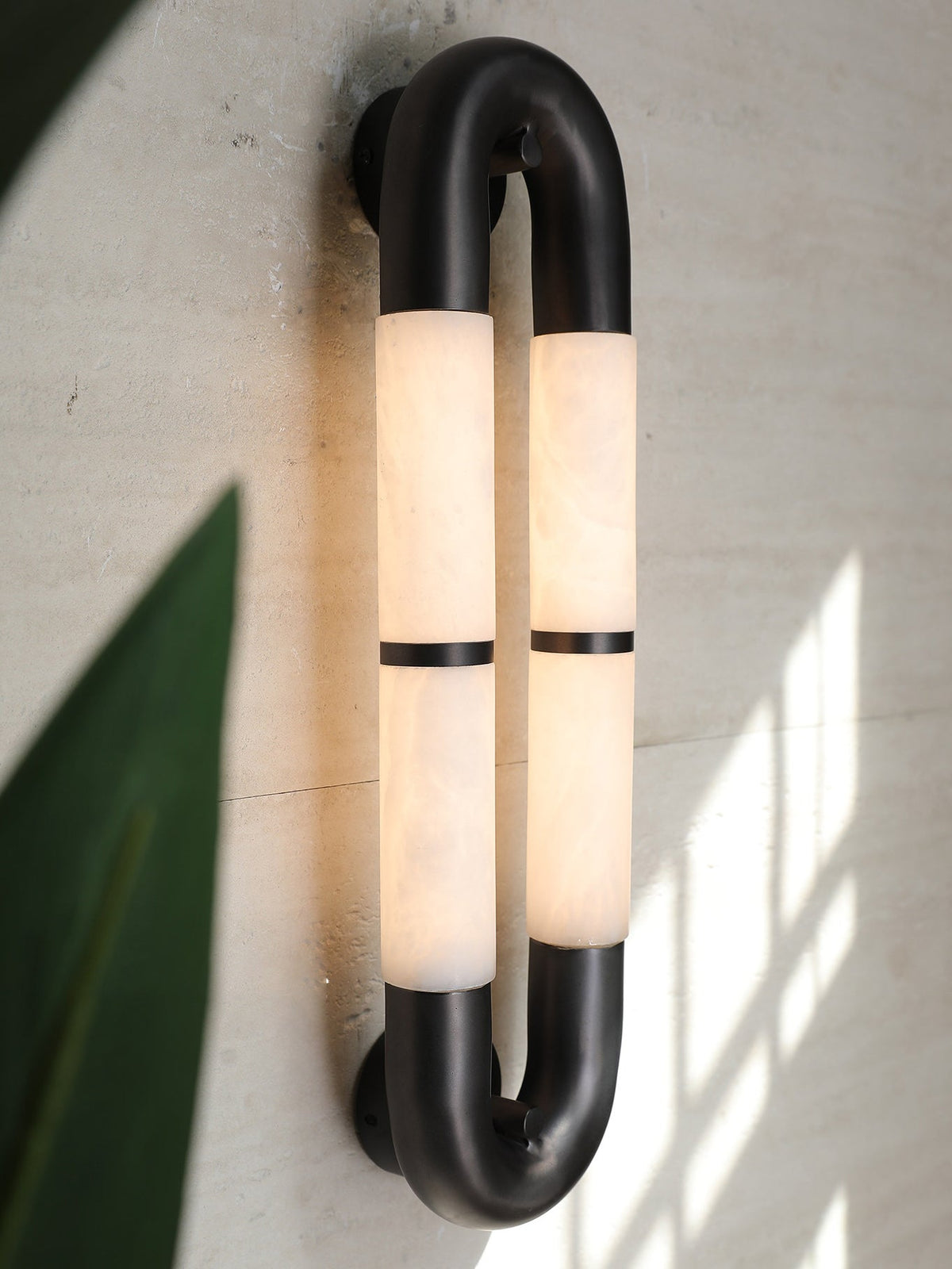 Lifestyle image showing two Mirabelle sconces flanking a piece of art.