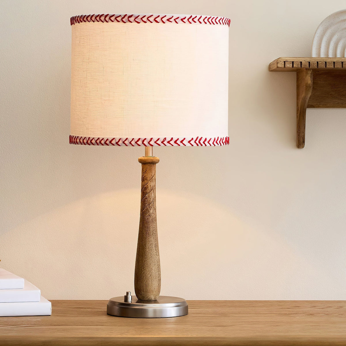 Close-up view of the Mitchell Table Lamp's walnut wood baseball bat body.