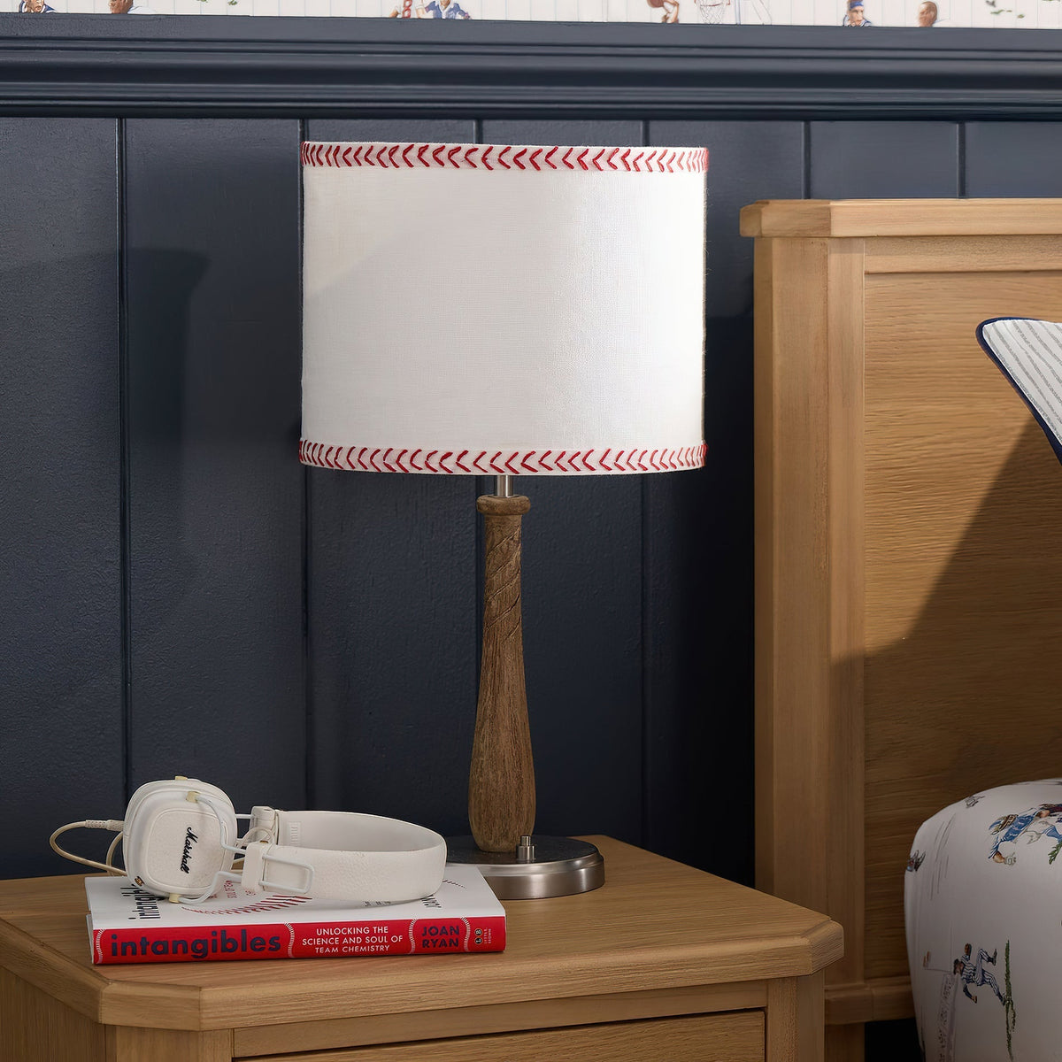 The Mitchell Table Lamp shown on a nightstand in a modern bedroom.