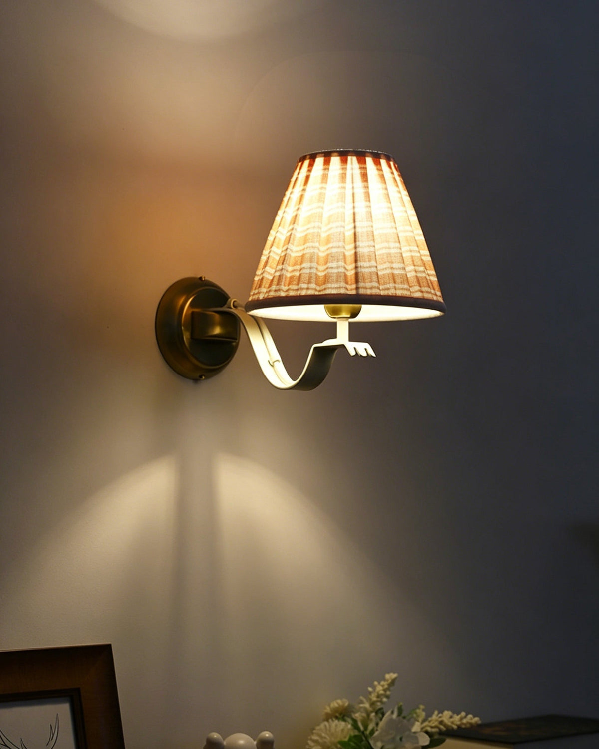Lifestyle image of the Penelope sconce in a decorated room.