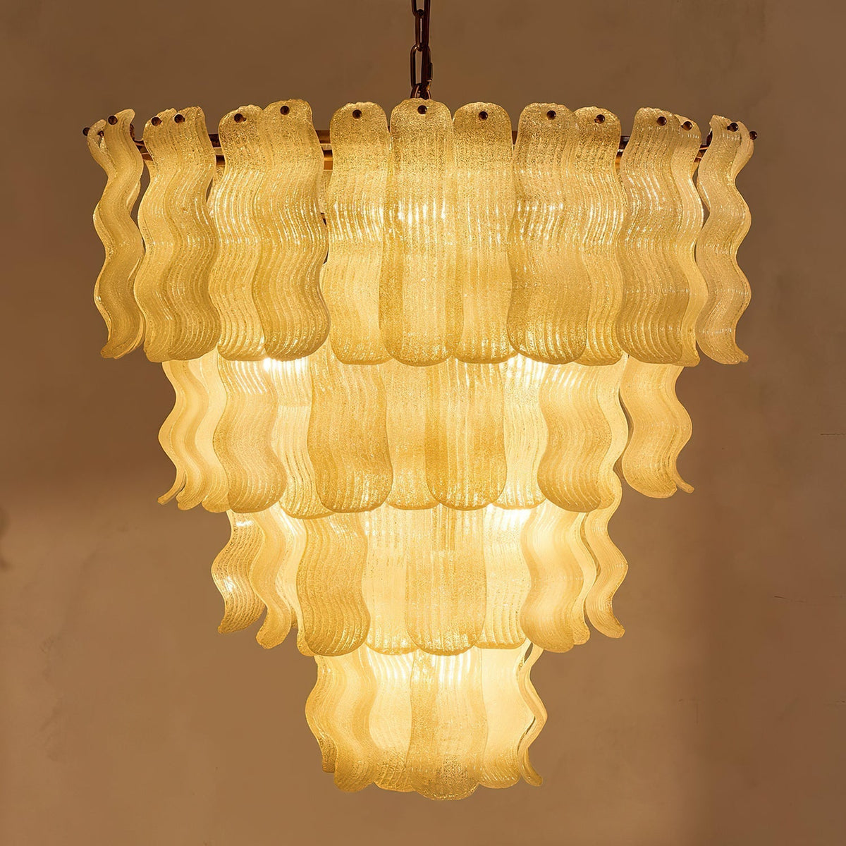 Lifestyle image of the Pollensa Textured Wave Chandelier in a dining room setting.