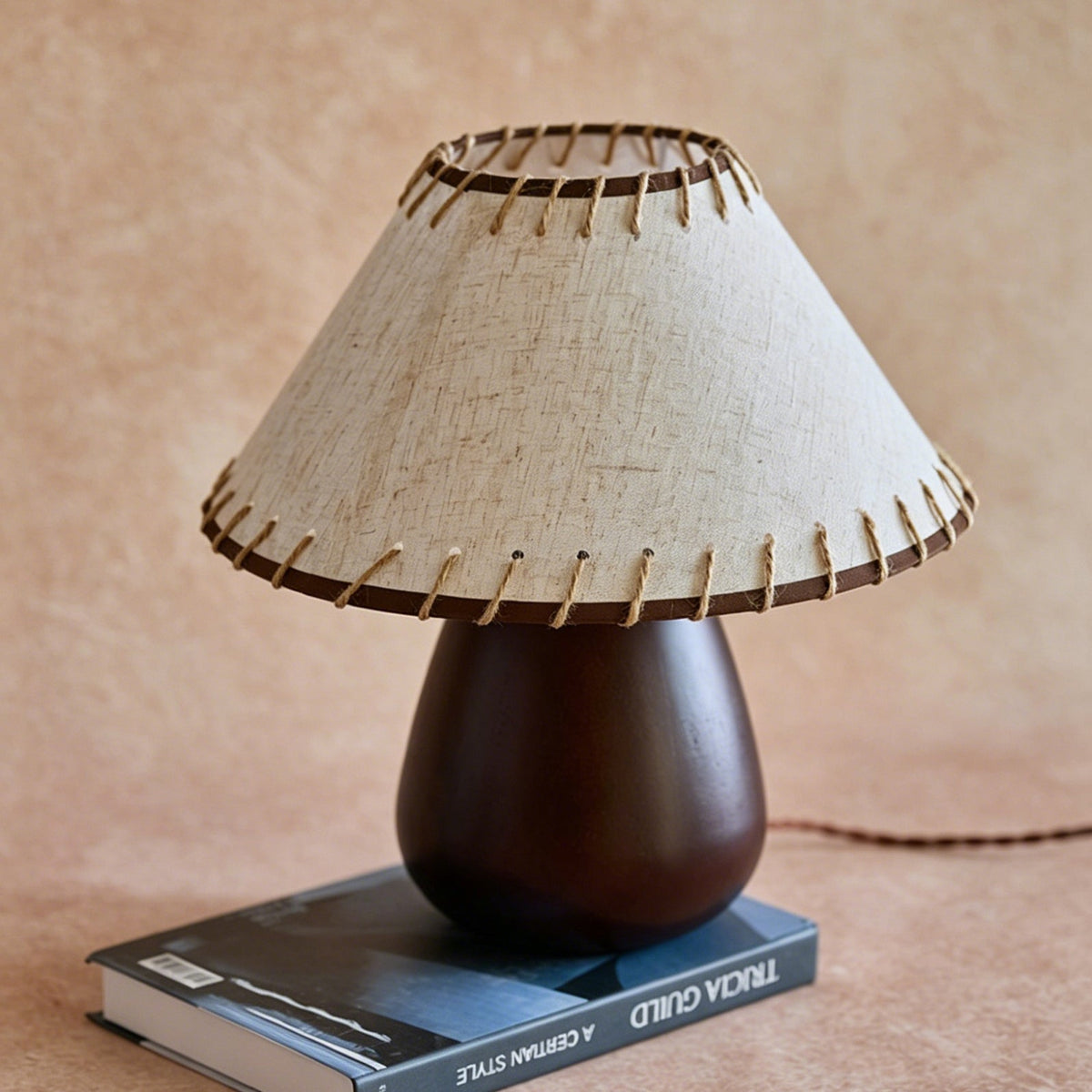Close-up view of the whipstitch detailing on the lamp's linen shade.