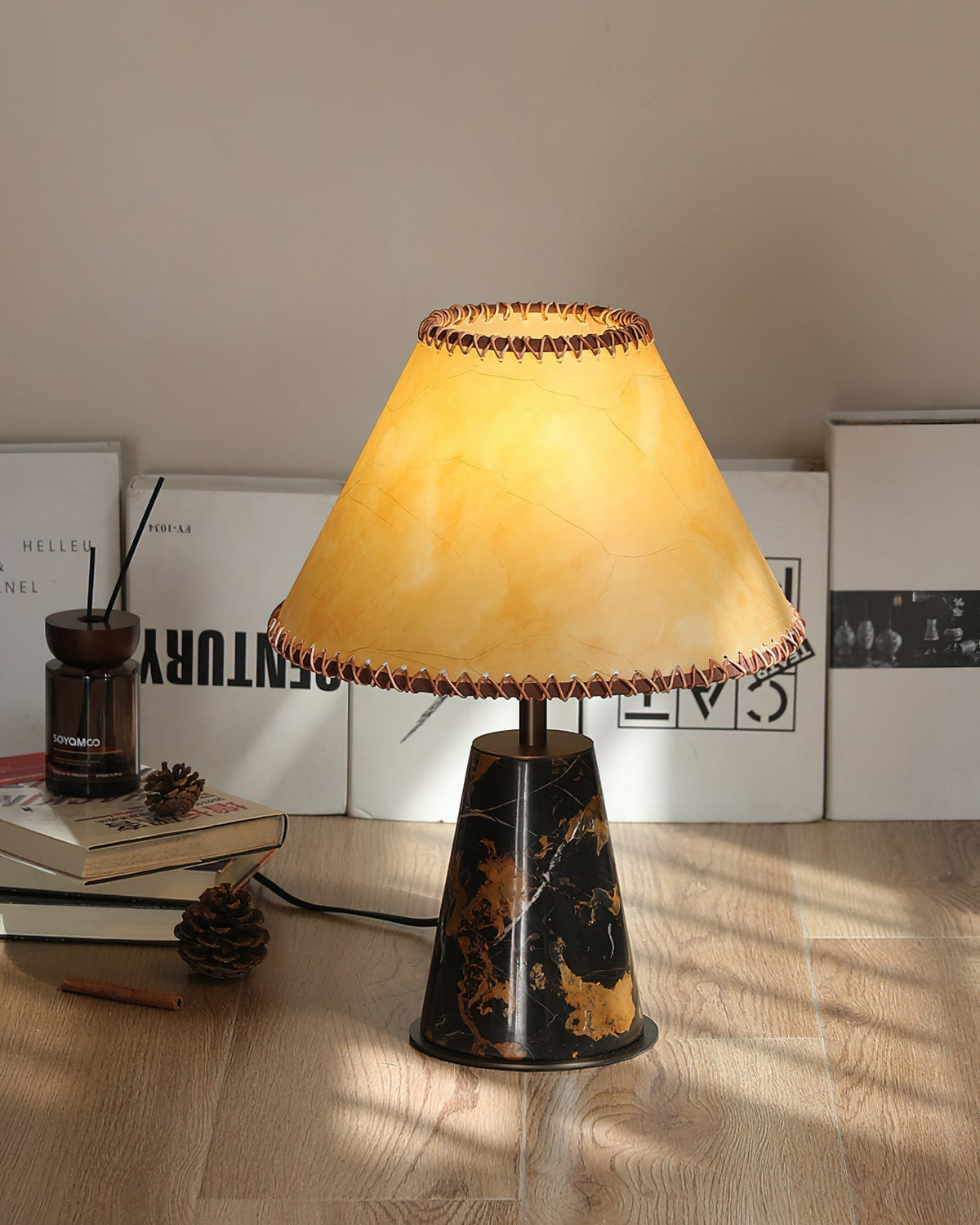 The lamp providing warm light on a bedroom nightstand.