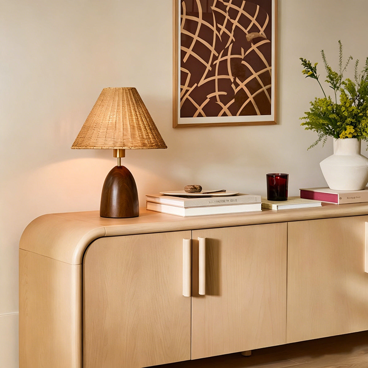 Suri Rattan Table Lamp illuminated, casting a warm glow.