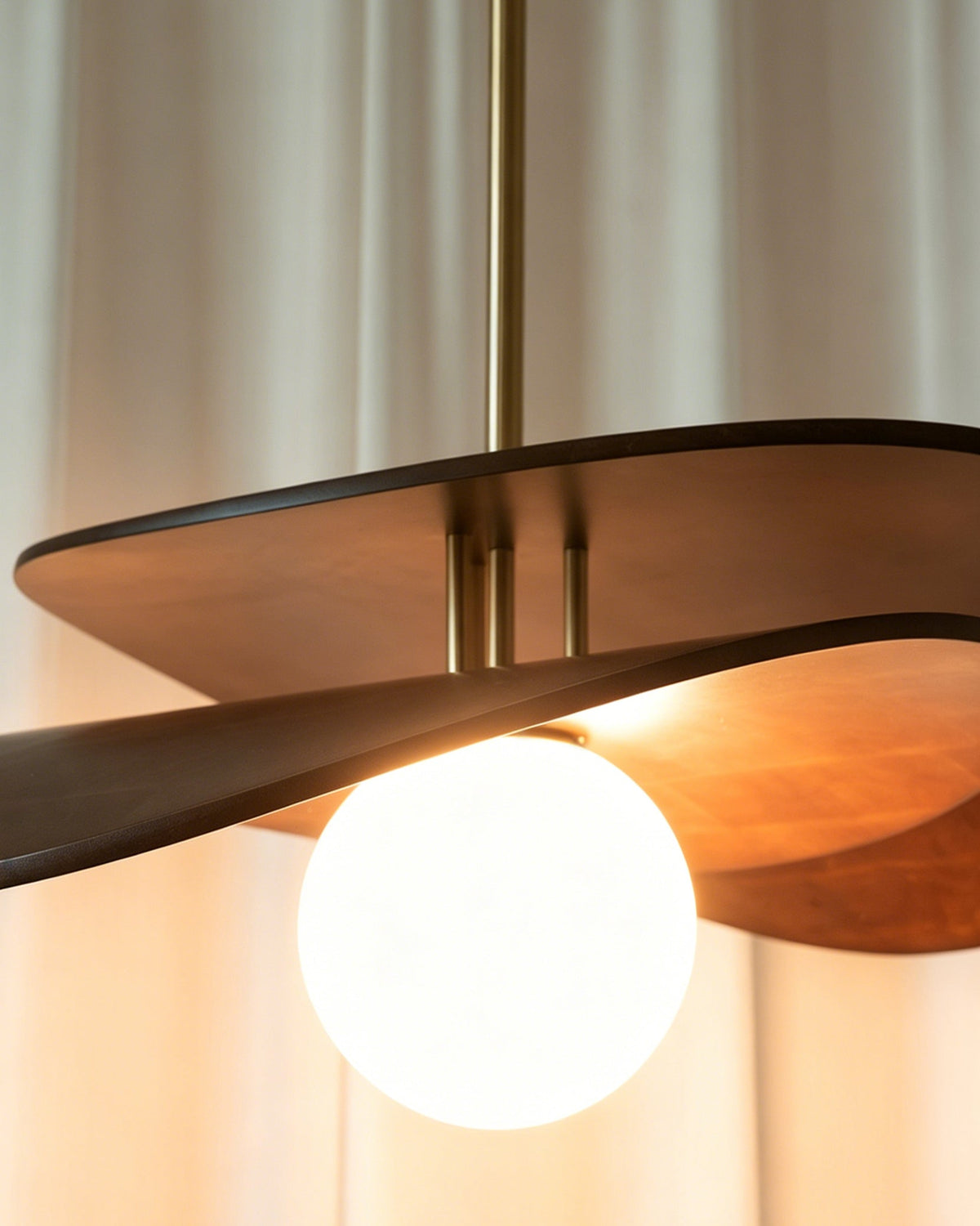 View from below the Zane pendant light, looking up at the illuminated globe.