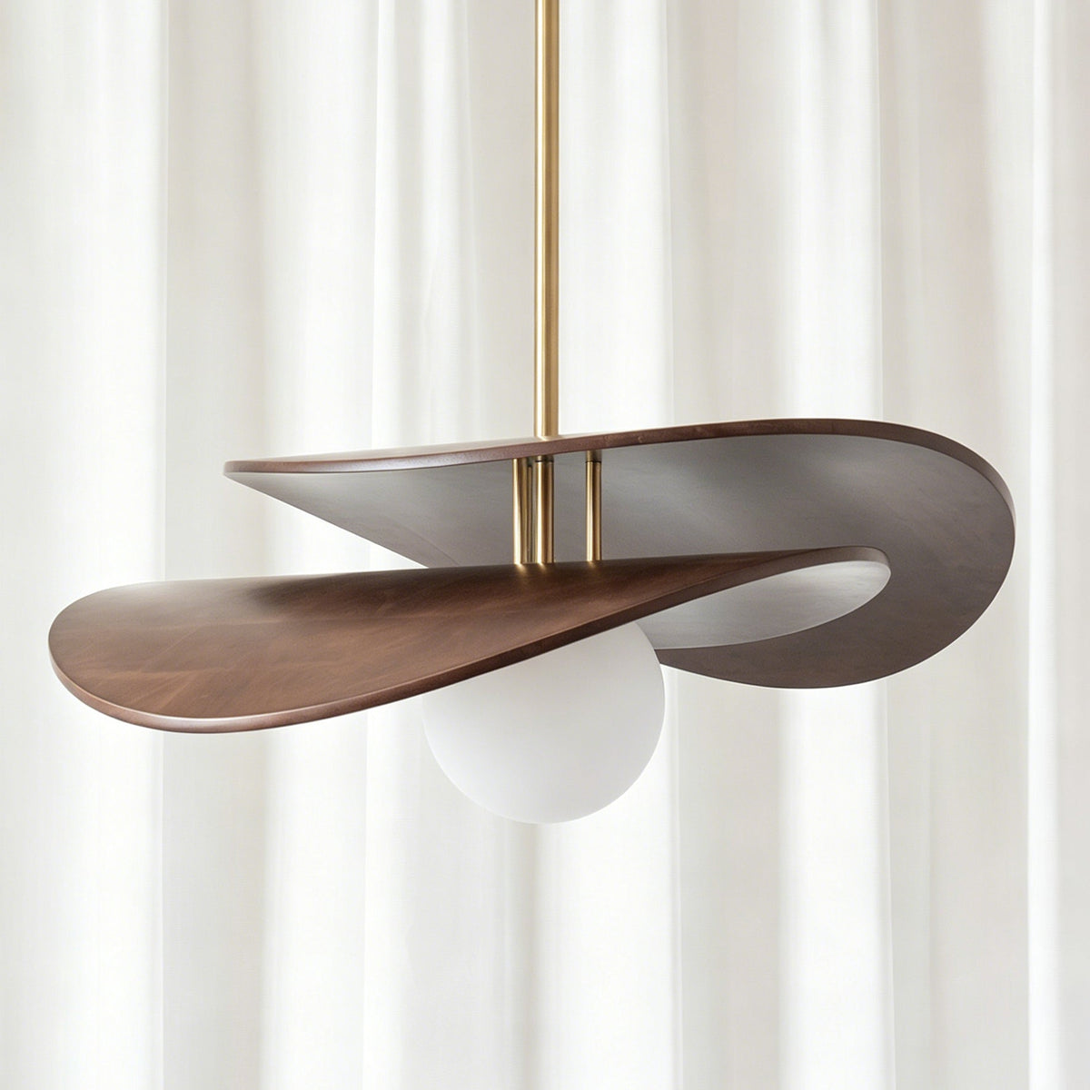 Angled view of the Zane walnut pendant light showcasing its curved wooden structure.