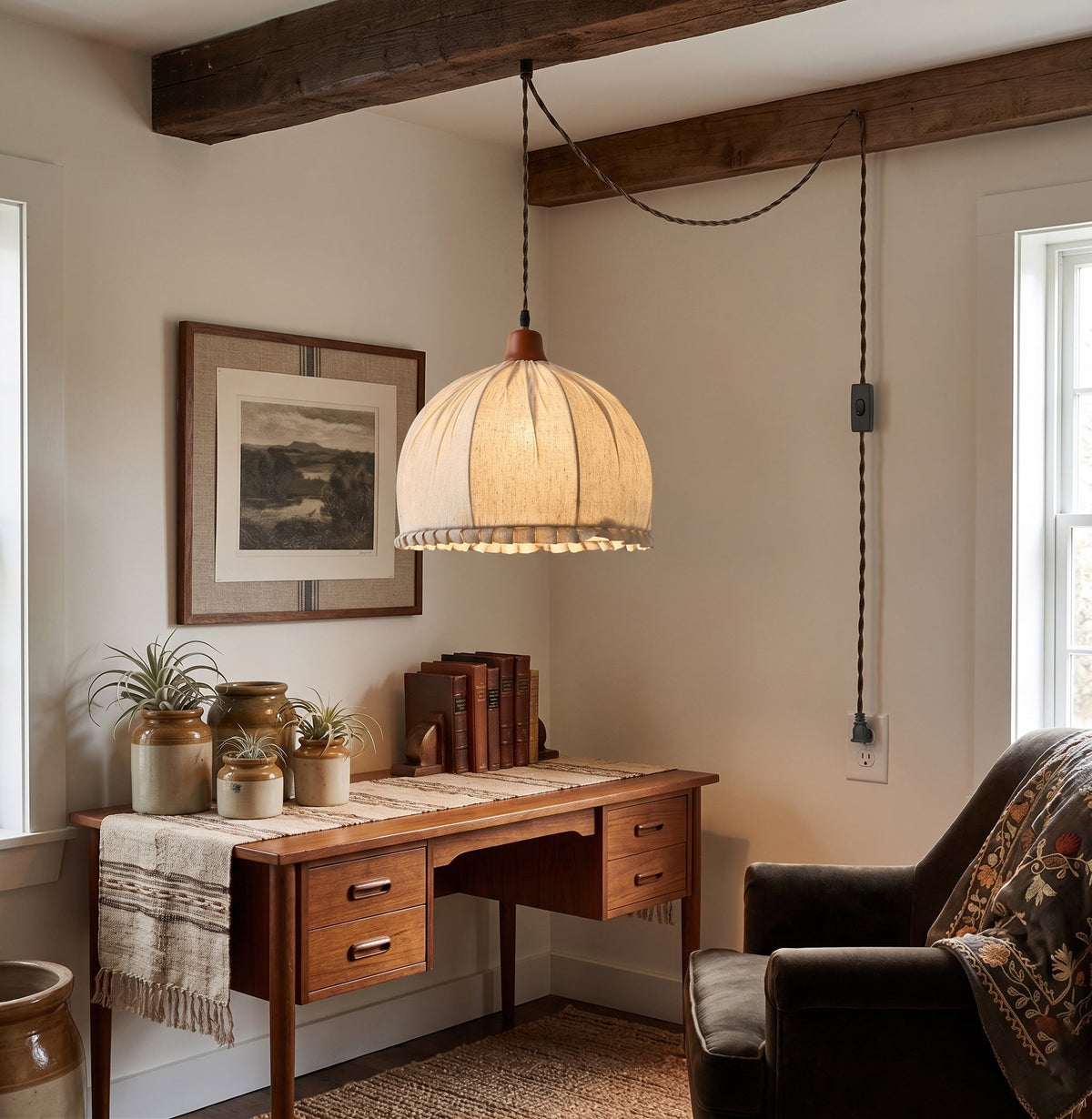Dippa Swag Pendant Light in a rich walnut color hanging in a modern living room.